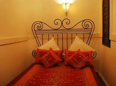 a group of pillows sitting on a bed at Riad La Perle de Marrakech in Marrakech