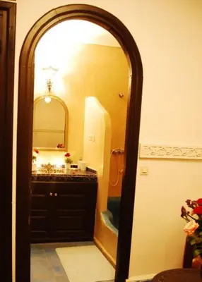 a bathroom with a large mirror and a sink at Riad La Perle de Marrakech in Marrakech