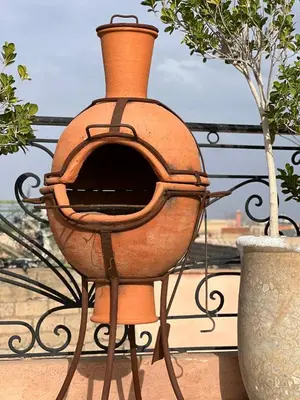 a large orange pot sitting on top of a fence at Riad dar Rbati in Marrakech