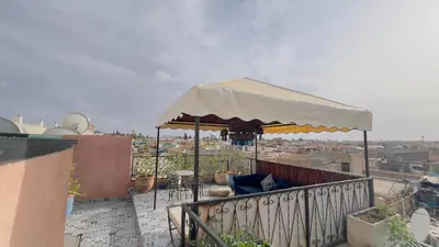 a large umbrella on top of a balcony at Riad dar Rbati in Marrakech