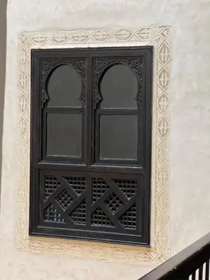 a black window on the side of a building at Riad dar Rbati in Marrakech