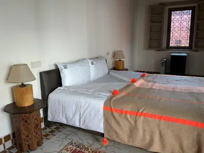 a bedroom with a bed and a window at Riad Al Massarah in Marrakech