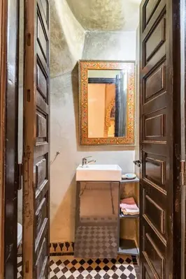 a bathroom with a sink and a mirror at Riad Anir in Marrakech