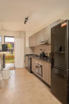 a kitchen with stainless steel appliances and a large window at LDM Appartements Marrakech in Marrakech