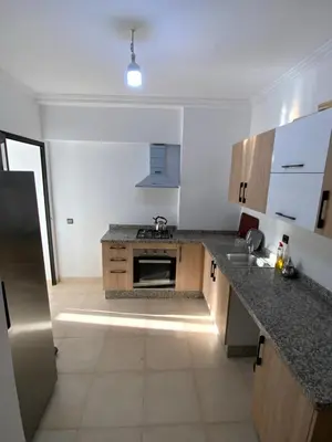 a kitchen with a sink and a stove top oven at Best Appartement 3 BEDROOMS in Marrakech