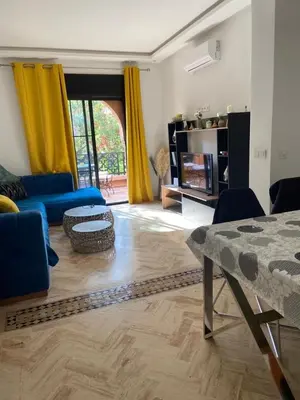 a living room with yellow curtains and a blue couch at Chez balqis atlas golf in Marrakech