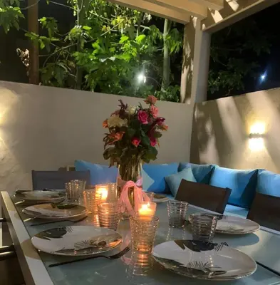 a table with candles and a vase with flowers on it at Villa piscine privée, Détente familiale Marrakech in Marrakech