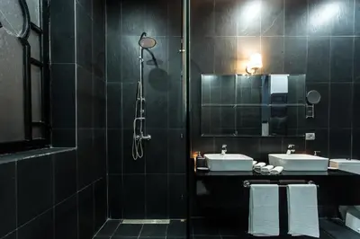 a bathroom with two sinks and a shower at The BIRD in Marrakech