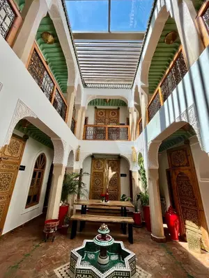 a large room with a wooden table in a building at Riad Dar Fanny in Marrakech