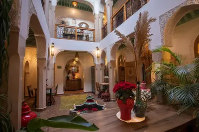 a large room with vases of flowers on a table at Riad Dar Fanny in Marrakech