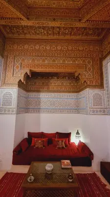 a bedroom with a red bed and a coffered ceiling at The Douiria in Marrakech
