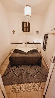 a bedroom with a large bed with a large rug at The Douiria in Marrakech