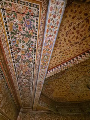 a coffered ceiling with a painting of flowers on it at The Douiria in Marrakech