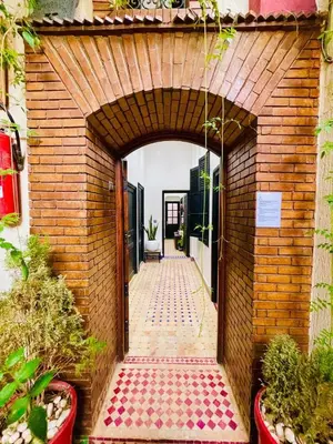 an entry way to a building with a brick wall at RIAD DOUIRTNA in Marrakech