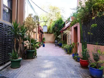 an alley with potted plants on the side of a building at RIAD DOUIRTNA in Marrakech