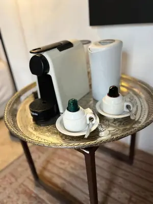 a table with a coffee maker and two cups on it at RIAD ENNAFOURA BOUTIQUE HOTEL in Marrakech
