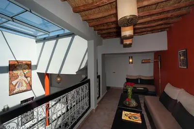 a living room with red walls and windows at Riad Mylaya in Marrakech