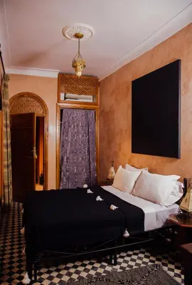a hotel room with a bed and a window at Riad Bensaid in Marrakech