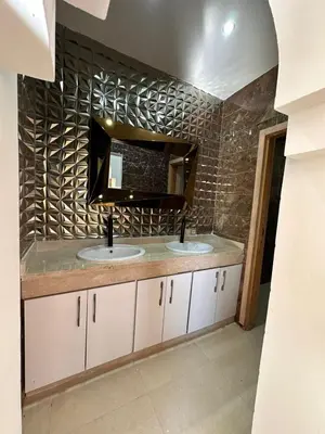 a bathroom with two sinks and a mirror at villa with private pool only family in Marrakech