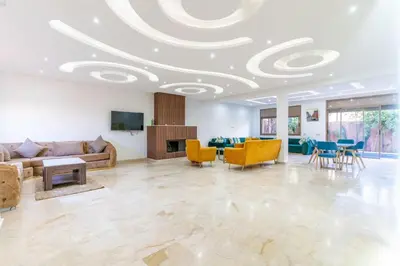 a living room with a coffered ceiling and yellow chairs at villa with private pool only family in Marrakech