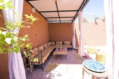 a living room with a couch and a table at RYAD RDATE LWALIDINE in Marrakech