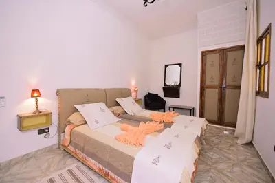 a bedroom with two beds in a room at RYAD RDATE LWALIDINE in Marrakech