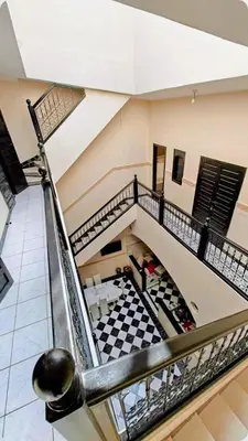 a staircase in a building with a checkered floor at Riad Lyna in Marrakech