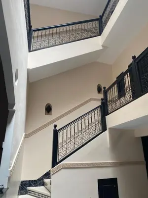 a staircase in a house with black railings at Riad Lyna in Marrakech