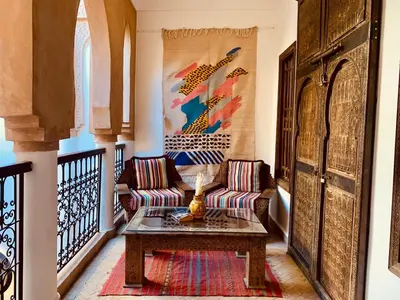 a living room with a couch and a table at Riad Laksiba in Marrakech