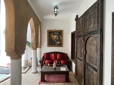 a living room with a couch and a table at Riad Laksiba in Marrakech