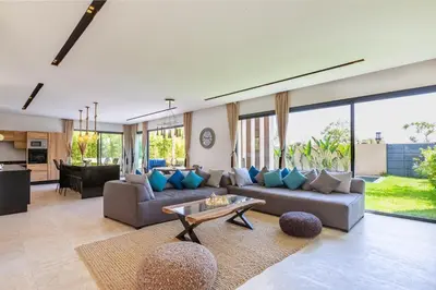 a living room with a couch and a table at Villa Nounja Golf Amelkis Marrakech in Marrakech