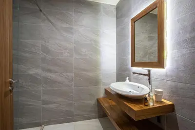 a bathroom with a sink and a mirror at Villa Nounja Golf Amelkis Marrakech in Marrakech