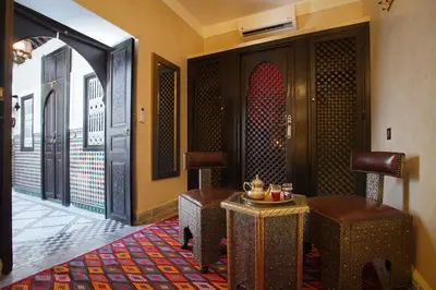 a lobby with two chairs and a table and a door at Riad Mazaj in Marrakech