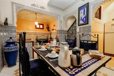 a dining room with a table with vases on it at Riad For S in Marrakech