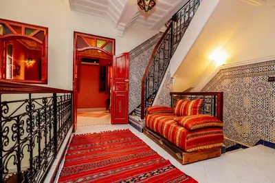 a room with a staircase with a couch and a rug at Riad For S in Marrakech