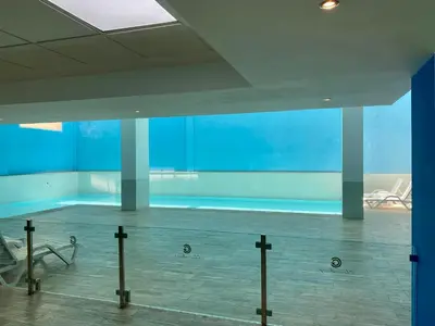 a room with a swimming pool with a blue wall at Appartement chambre salon centre de Gueliz 22 in Marrakech
