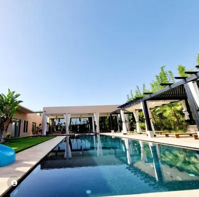 a swimming pool in front of a building at Villa Le Clos de l'Atlas in Marrakech