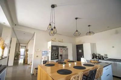 a kitchen with a large wooden table in a room at Villa Le Clos de l'Atlas in Marrakech