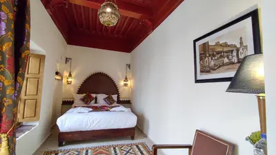 a bedroom with a bed in a room with a ceiling at RIAD DAR En-Nawat in Marrakech