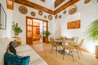 a living room with a table and chairs at RIAD THE MILESTONE in Marrakech