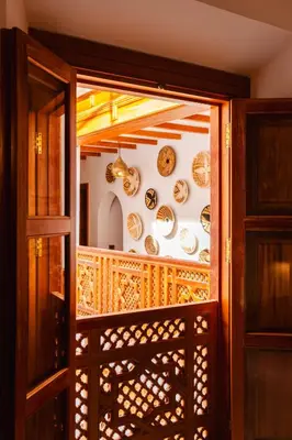 an open door with plates on the wall at RIAD THE MILESTONE in Marrakech