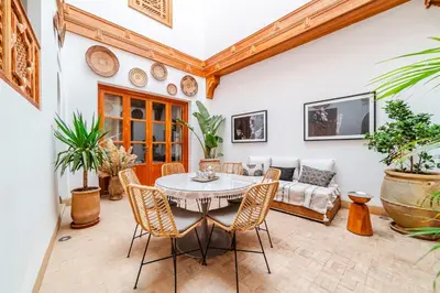 a living room with a table and chairs at RIAD THE MILESTONE in Marrakech