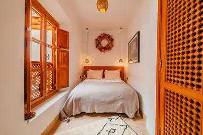 a bedroom with a bed and a window at RIAD THE MILESTONE in Marrakech