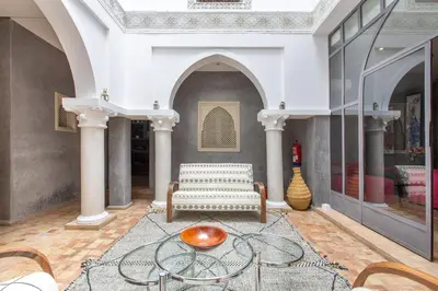 a living room with a couch and a table at Riad Princesse Des Sables- Jaccuzzi& SPA-Breakfast in Marrakech