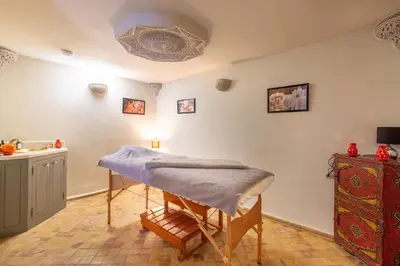 a room with a table and a sink at Riad Princesse Des Sables- Jaccuzzi& SPA-Breakfast in Marrakech
