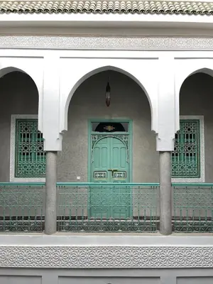 a green door on a building with two arches at Riad Deux Palmiers in Marrakech