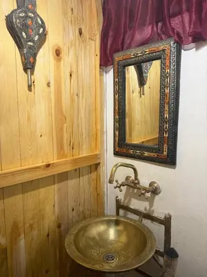 a bathroom with a sink and a mirror at Riad Deux Palmiers in Marrakech