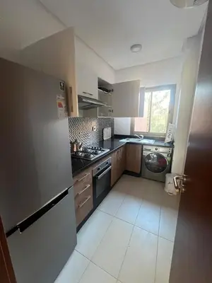 a kitchen with a sink and a stove top oven at Appartement Vue golf Marrakech in Marrakech