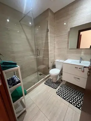 a bathroom with a shower and a toilet and a sink at Appartement Vue golf Marrakech in Marrakech