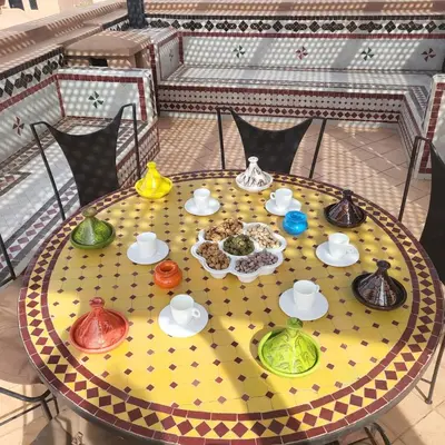 a table with different colored bowls and plates on it at Atlas golf rossort in Marrakech